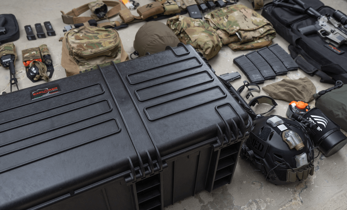 A large explorer 97433 gun case filled with various items, including a helmet, goggles, and other exploration gear.